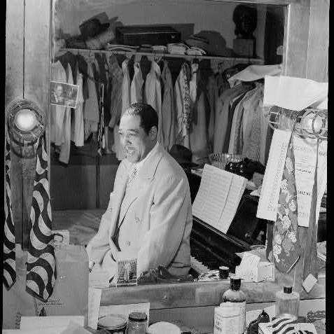 Duke Ellington, amid "his 20 suits, 15 shirts, suede shoes and his ever present piano" in his dressing room at the Paramount Theater in New York in September 1946.