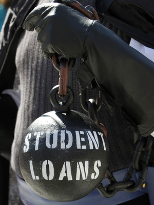 Gan Golan holds a ball and chain representing his college loan debt during at a Occupy DC event last year.