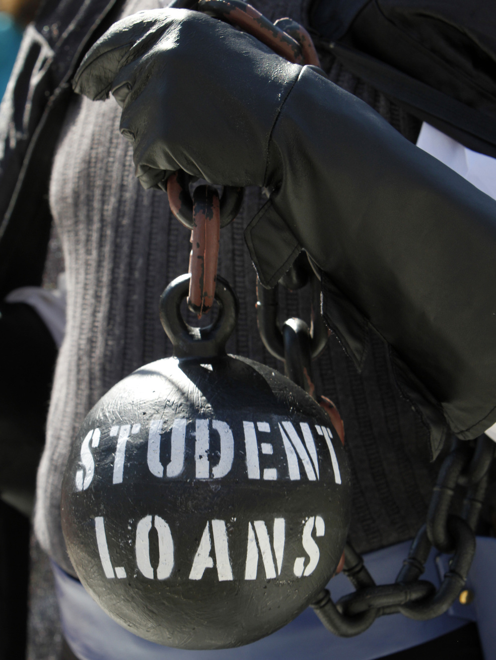 Gan Golan holds a ball and chain representing his college loan debt during at a Occupy DC event last year.