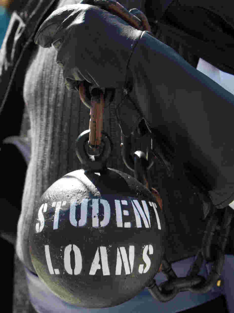 Gan Golan holds a ball and chain representing his college loan debt during at a Occupy DC event last year.