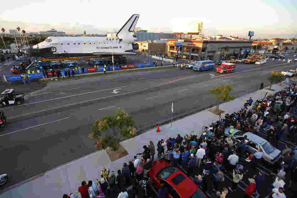 Spectators gather to watch the space shuttle Endeavour in Los Angeles on Friday. Endeavour's 12-mile road trip kicked off shortly before midnight Thursday as it moved from its Los Angeles International Airport hangar en route to the California Science Center, its ultimate destination. Spectators gather to watch the space shuttle Endeavour in Los Angeles on Friday. Endeavour's 12-mile road trip kicked off shortly before midnight Thursday as it moved from its Los Angeles International Airport hangar en route to the California Science Center, its ultimate destination.