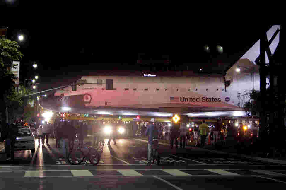 The space shuttle Endeavour leaves Los Angeles International Airport hangar for the streets of Los Angeles in the early morning. The space shuttle Endeavour leaves Los Angeles International Airport hangar for the streets of Los Angeles in the early morning.
