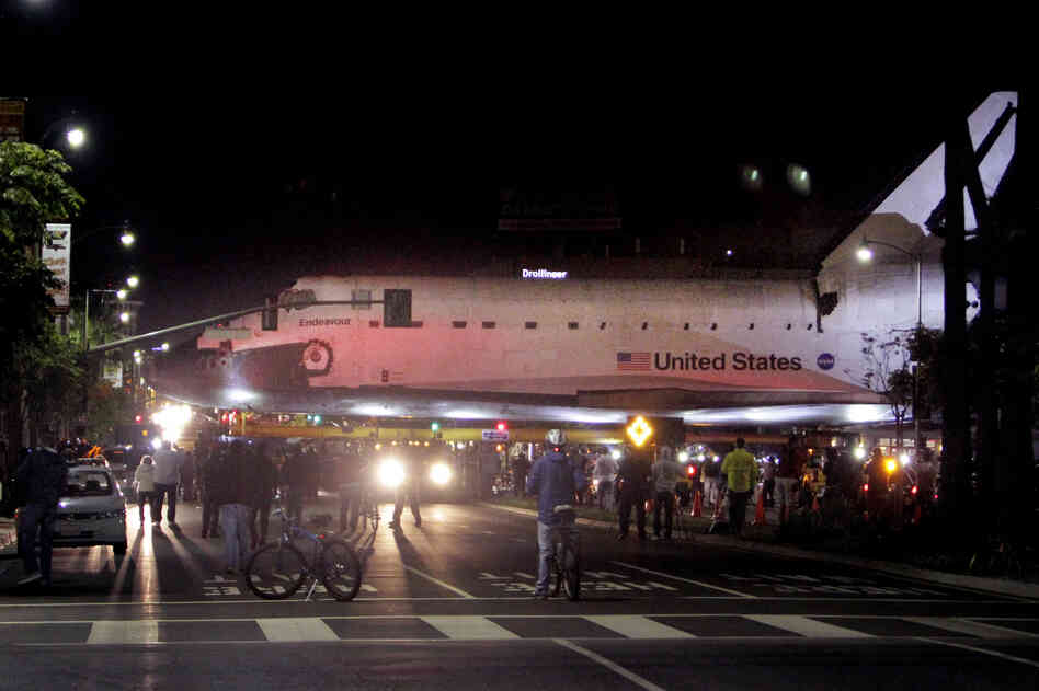 The space shuttle Endeavour leaves Los Angeles International Airport hangar for the streets of Los Angeles in the early morning.