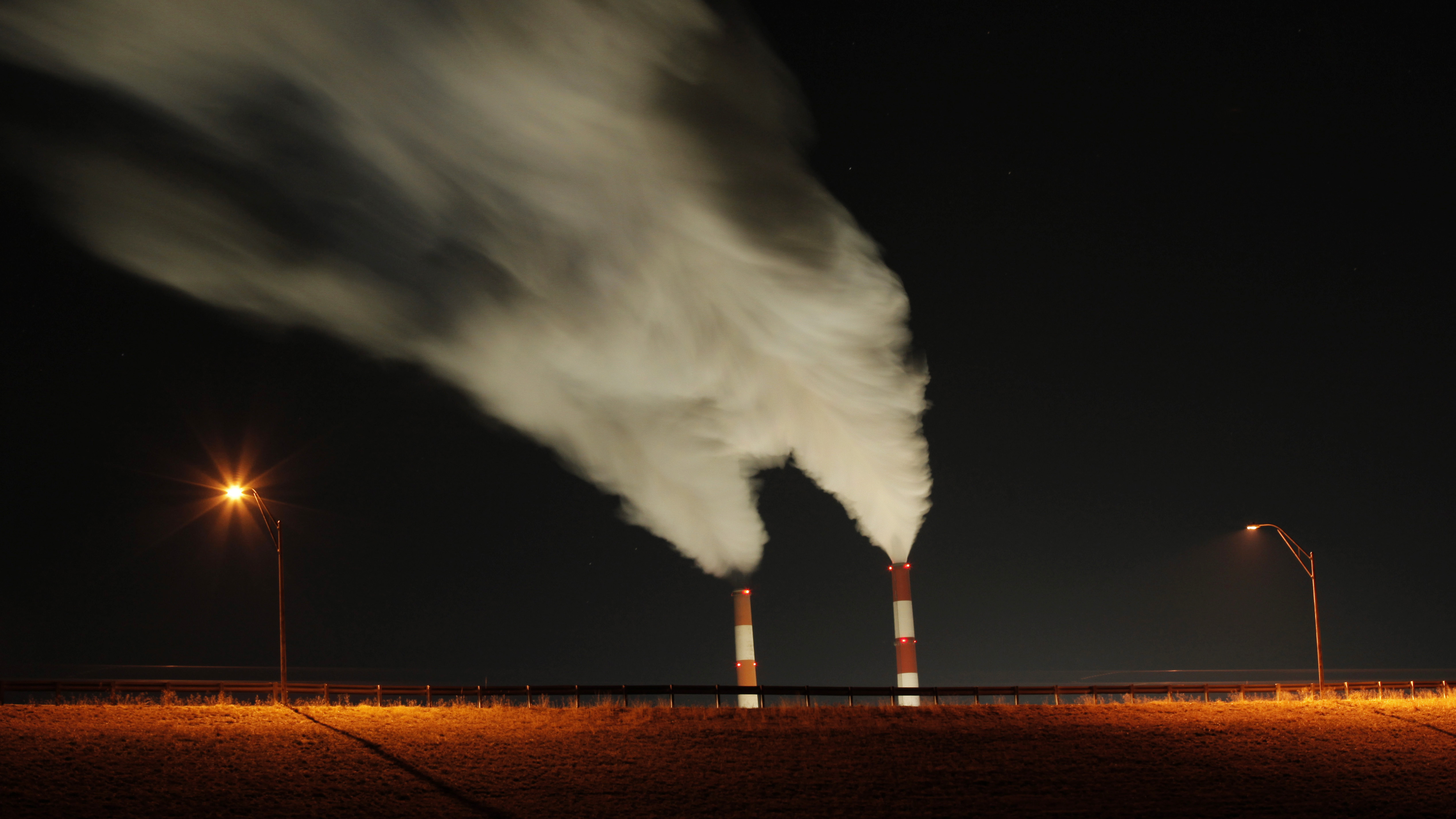 Smoke rises from the stacks of the La Cygne Generating Station coal-fired power plant in La Cygne, Kan. President Obama's regulation of the coal industry has come under fire from his Republican challenger, Mitt Romney.