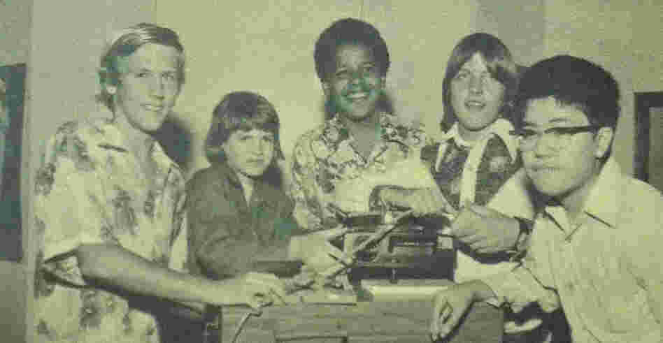 Barack Obama in a 1975 photo from the Punahou School yearbook. He and his eighth-grade homeroom classmates pose with a slide projector as part of the yearbook's theme of "Nostalgia."