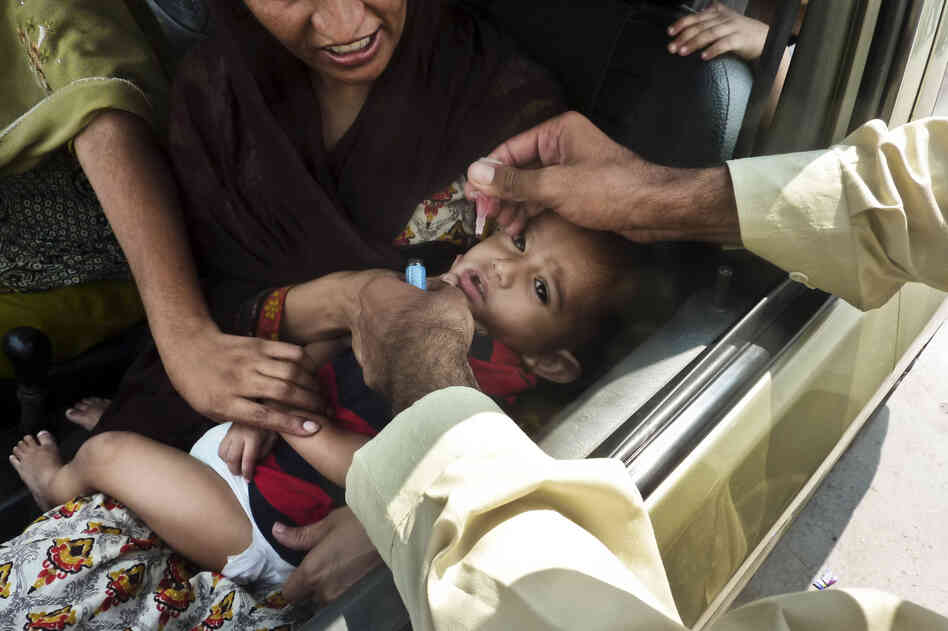 A child is inoculated with the polio vaccine at a traffic checkpoint just outside Pakistan's capital, Islamabad. Last year, Pakistan had the highest number of polio cases — 198.