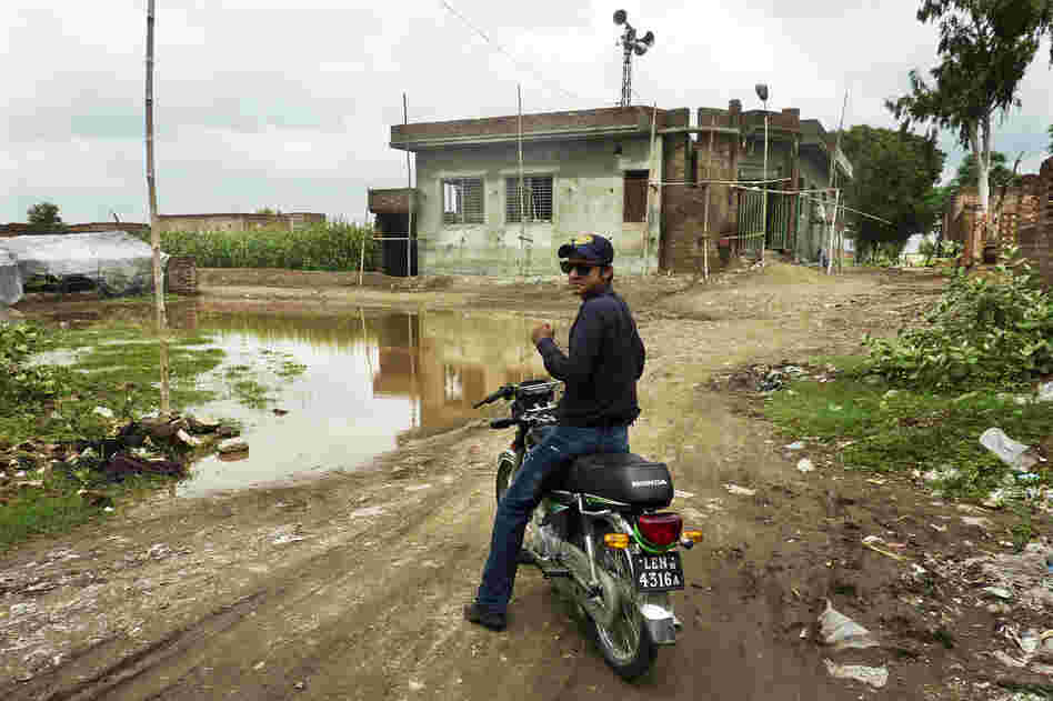 Social mobilizer Omer Feroze makes his way through a Lahore slum as part of an effort to educate people about polio and dispel any rumors about the vaccine. Misconceptions about the vaccine are rife within the country's population.