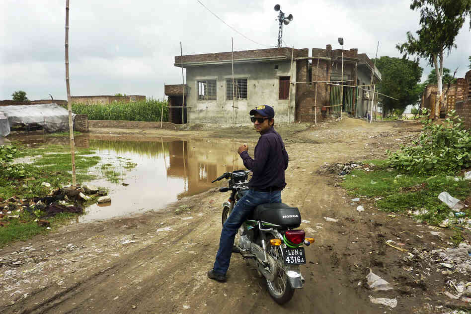 Social mobilizer Omer Feroze makes his way through a Lahore slum as part of an effort to educate people about polio and dispel any rumors about the vaccine. Misconceptions about the vaccine are rife within the country's population.