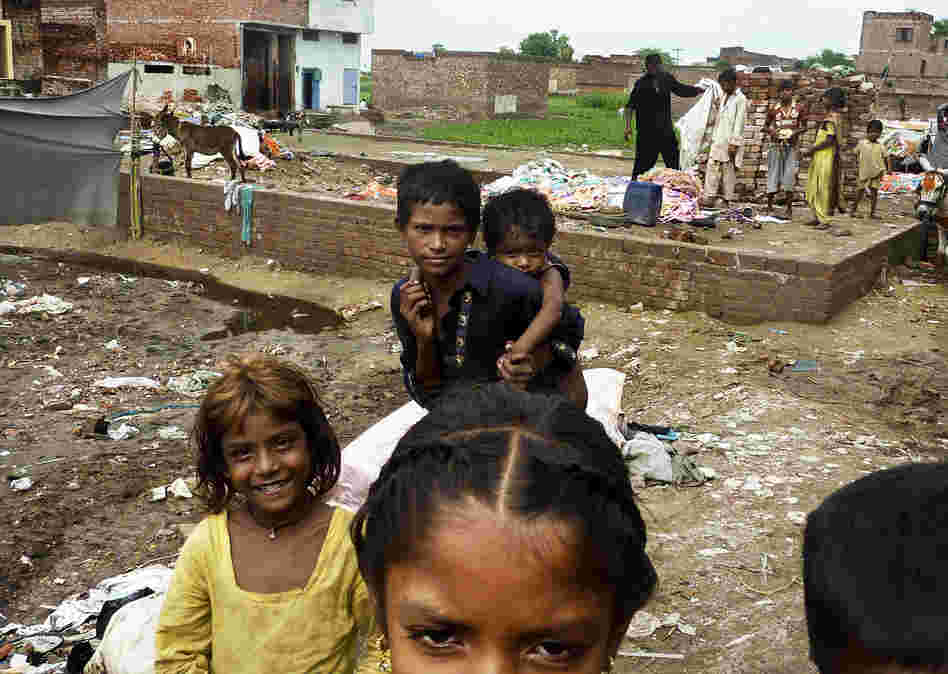 Children in a Lahore slum after heavy rains. The slum has a large population of Pashtuns who came from Pakistan's lawless tribal regions; many carry the polio virus with them.