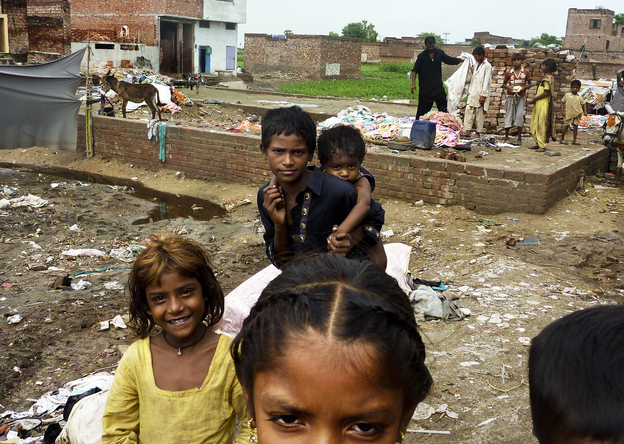 Children in a Lahore slum after heavy rains. The slum has a large population of Pashtuns who came from Pakistan's lawless tribal regions; many carry the polio virus with them.