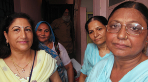 Dr. Kiran Kathuria (left) and veteran volunteer Santosh Sharma (front right) make the rounds with a team of vaccinators in Nehru Nagar, a middle-class area of Delhi. India's nationwide polio eradication program, begun in 1995, was modeled after Delhi's.