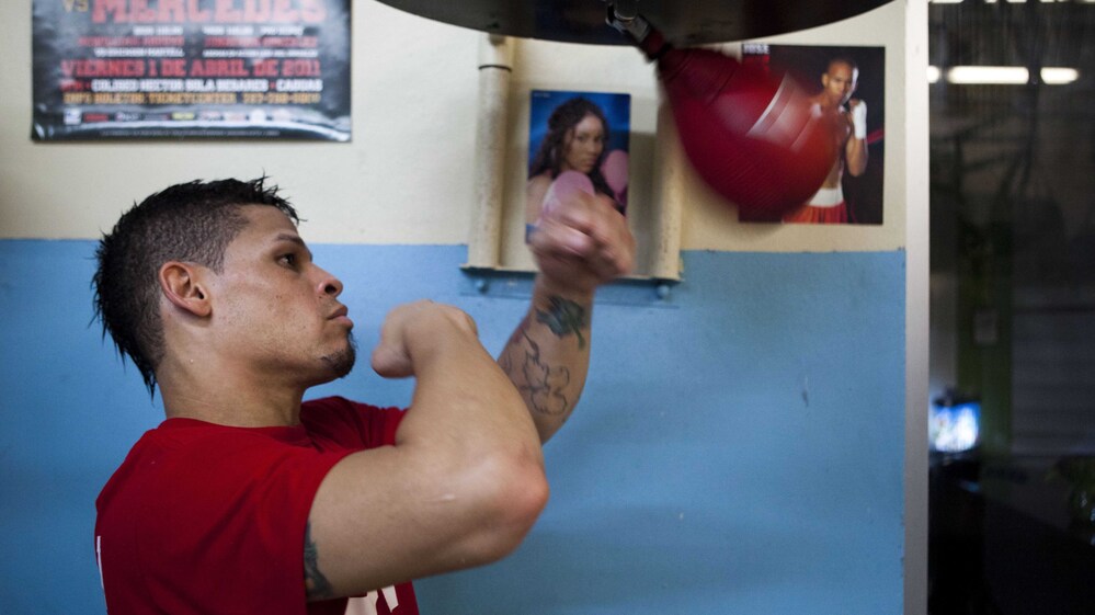 Boxer Orlando Cruz hits a speed bag at a public gym in San Juan, Puerto Rico, on Oct. 4. He came out as a gay man earlier this month.
