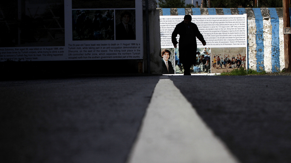 A man in silhouette crosses the Ledra Palace checkpoint leading to the Greek Cypriot area by the U.N. buffer zone (Green line) that divides Nicosia, Cyprus. A man in silhouette crosses the Ledra Palace checkpoint leading to the Greek Cypriot area by the U.N. buffer zone (Green line) that divides Nicosia, Cyprus.