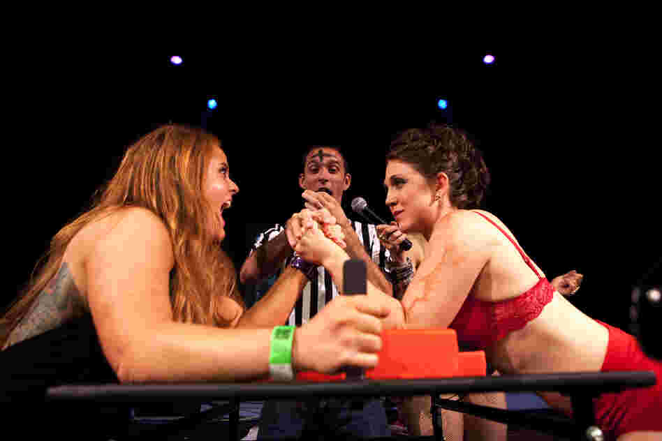 "Ze Dirty Butcher," (right) locks elbows with "Pain Fonda" in her first match of the night. Dyer lost the bout, but got her pride back in a dance-off rematch.