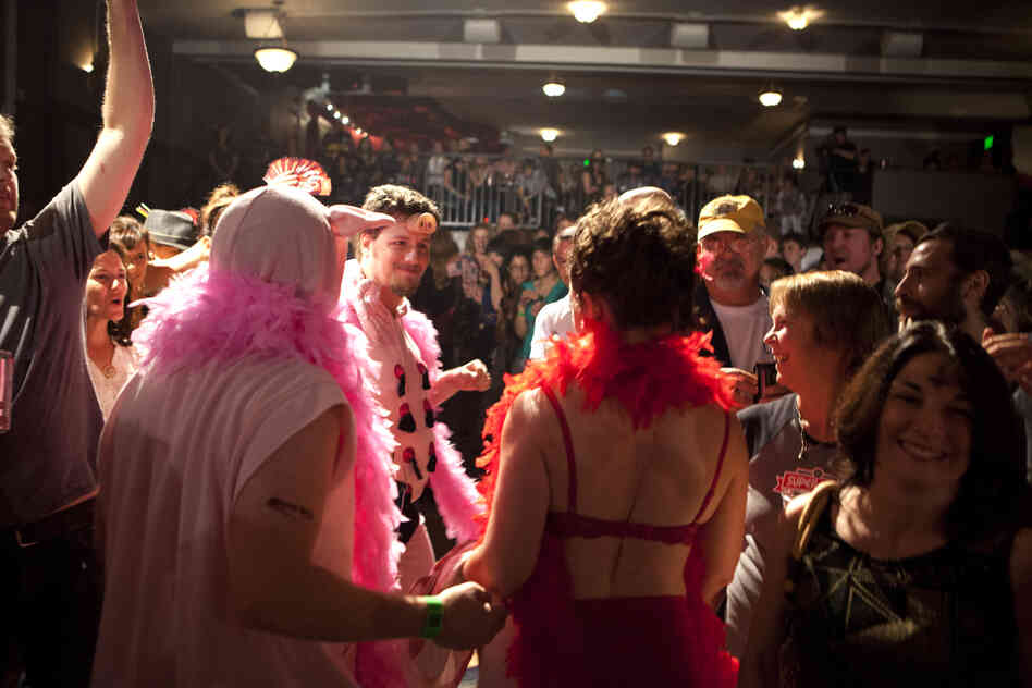 Dyer is greeted by her entourage of burlesque pigs after losing her match. Her husband Cliff, seen here with a pig nose on his forehead, was there to greet her.