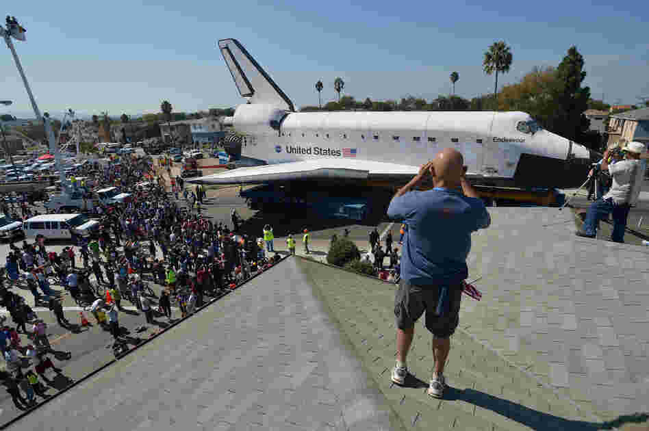 At every turn of Endeavour's stop-and-go commute through urban streets, a constellation of spectators trailed along as the space shuttle ploddingly nosed past stores, schools, churches and front yards.