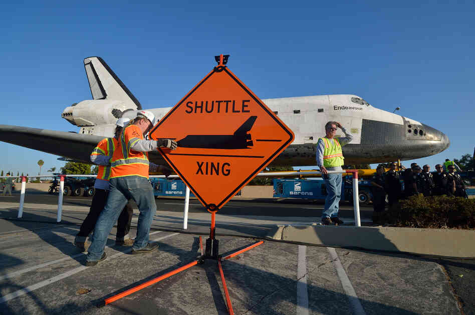 After trundling out of the Los Angeles International Airport on Friday, Endeavour hit the pavement before dawn again on Saturday on a remote-controlled 160-wheel carrier past diamond-shaped "Shuttle Xing" signs.