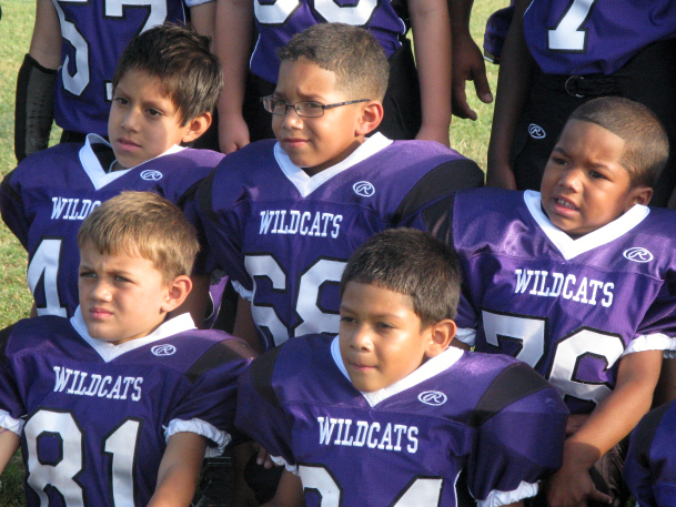 The Angleton Wildcats pose for picture day. The team of 7- and 8-year-olds is from the south Texas town of Angleton. (Image credit: NPR)