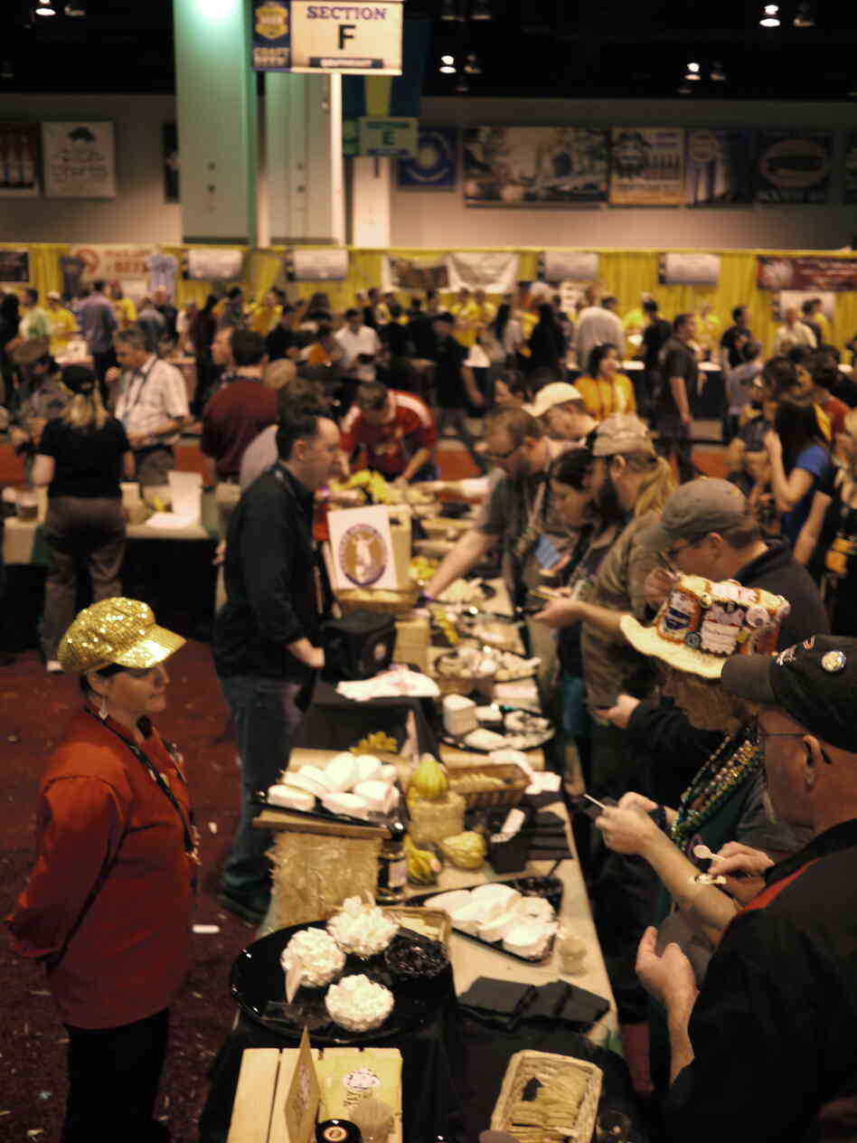 Festival goers line up for cheese between beer tastings. Many people arrive at the festival wearing necklaces hung with pretzels to munch on.