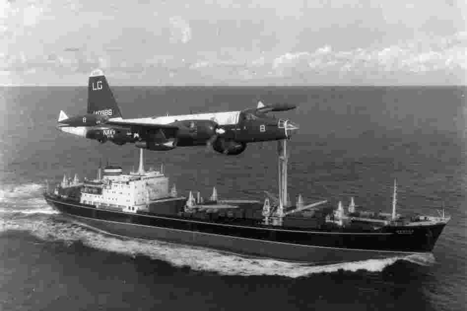A P2V Neptune U.S. patrol plane flies over a Soviet freighter during the Cuban missile crisis in 1962.