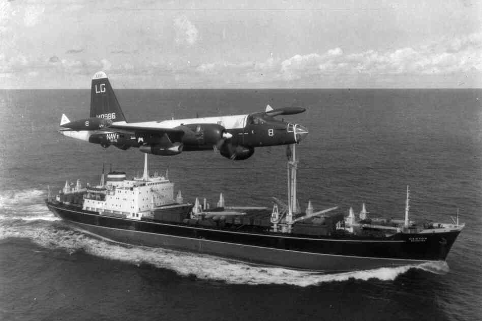 A P2V Neptune U.S. patrol plane flies over a Soviet freighter during the Cuban missile crisis in 1962.