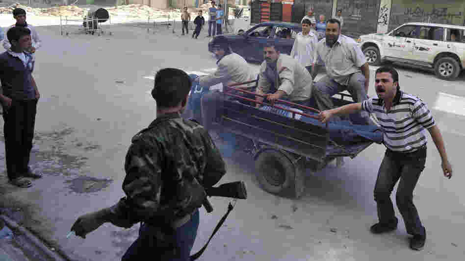 Syrians deliver an injured civilian to a hospital in the northern city of Aleppo on Saturday, following shelling by government forces.