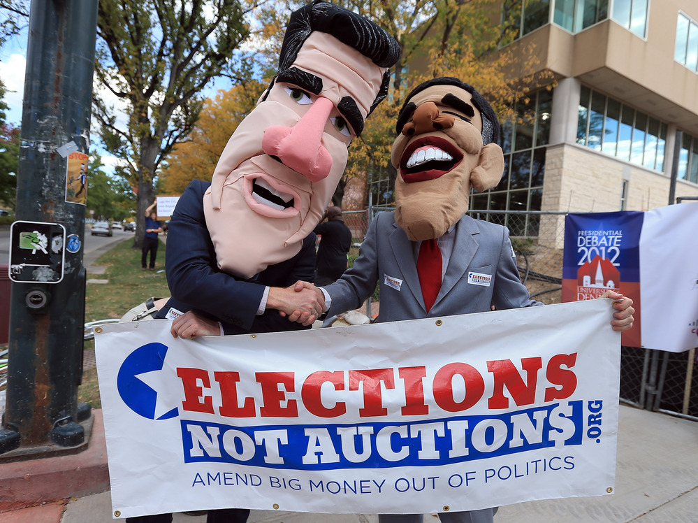 Costumed demonstrators on Oct. 3 in Denver, before the first presidential debate.