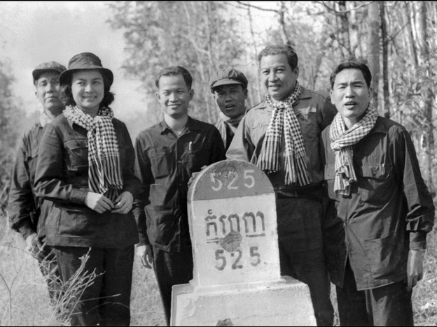 Sihanouk (second from right) poses with Khieu Samphan (third from left), a top Khmer Rouge leader, next to a milestone marking the distance to Phnom Penh, the Cambodian capital, in 1973.