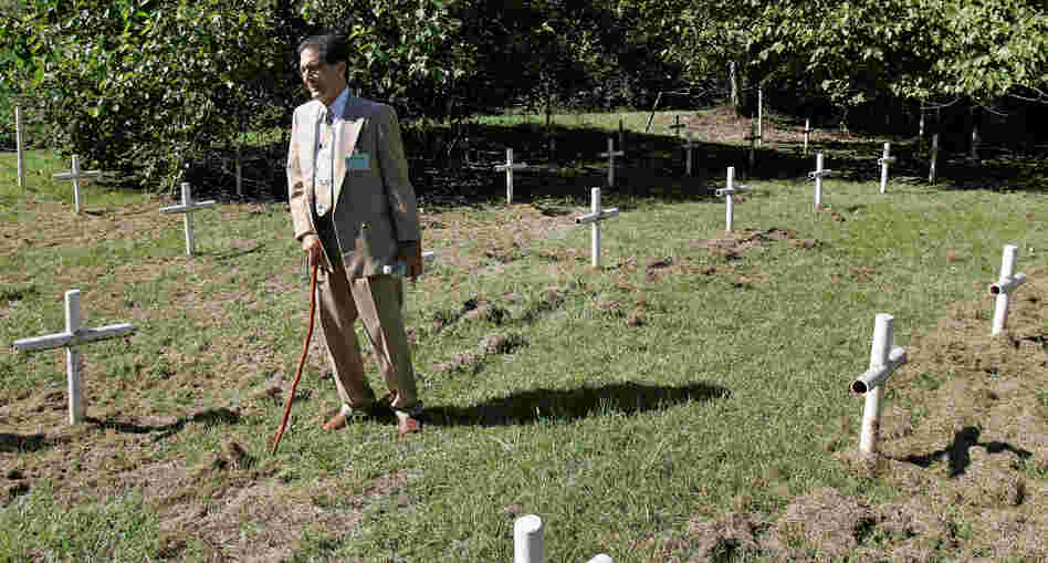 Dick Colon, one of the White House Boys, walks through grave sites near the Dozier School for Boys in Marianna, Fla. Several men who suffered abuse and severe beatings believe the crosses mark the graves of boys who were killed at the school, victims of punishments that went too far.