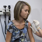An 18-year-old girl winces as she has her third and final shot of the HPV vaccine. An 18-year-old girl winces as she has her third and final shot of the HPV vaccine.