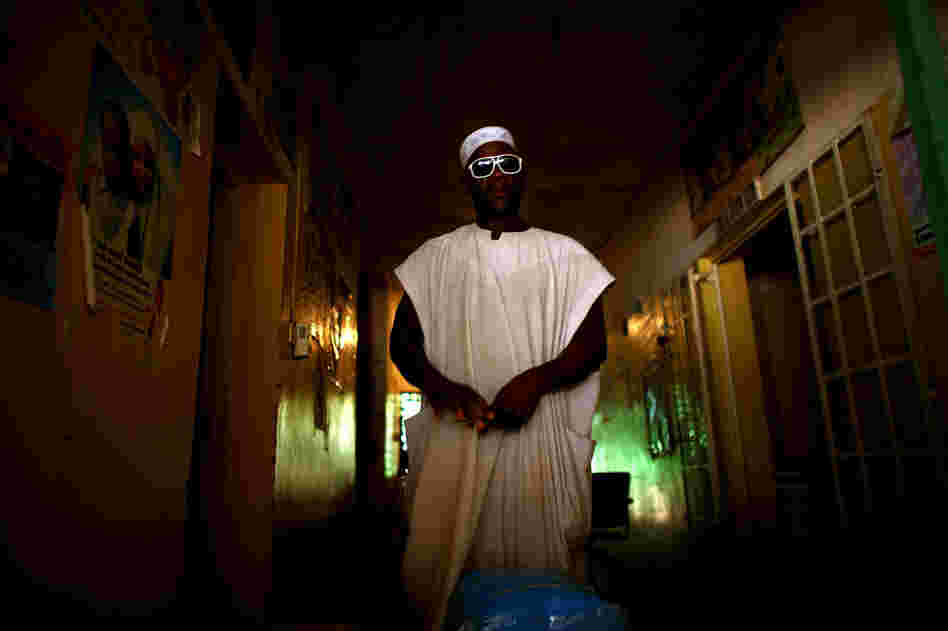 A nurse at the health clinic in Minjibir prepares to distribute free bed nets to combat malaria. Campaigns like this one, which offers services for malaria, attract local residents to the clinic. While they're there, residents are encouraged to get their children vaccinated against polio.