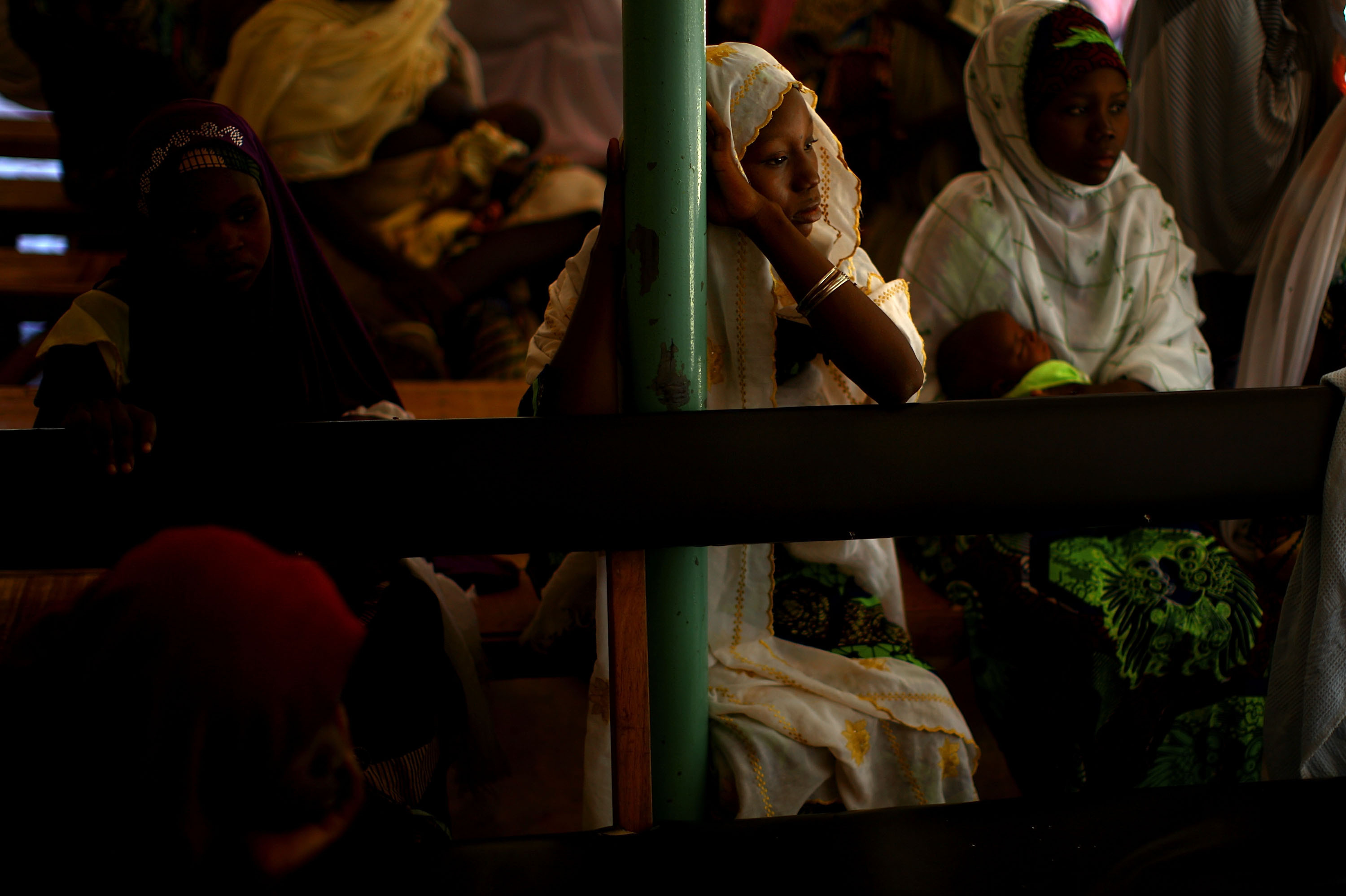 At the health clinic in Minjibir, women wait for their children to receive the polio vaccine.