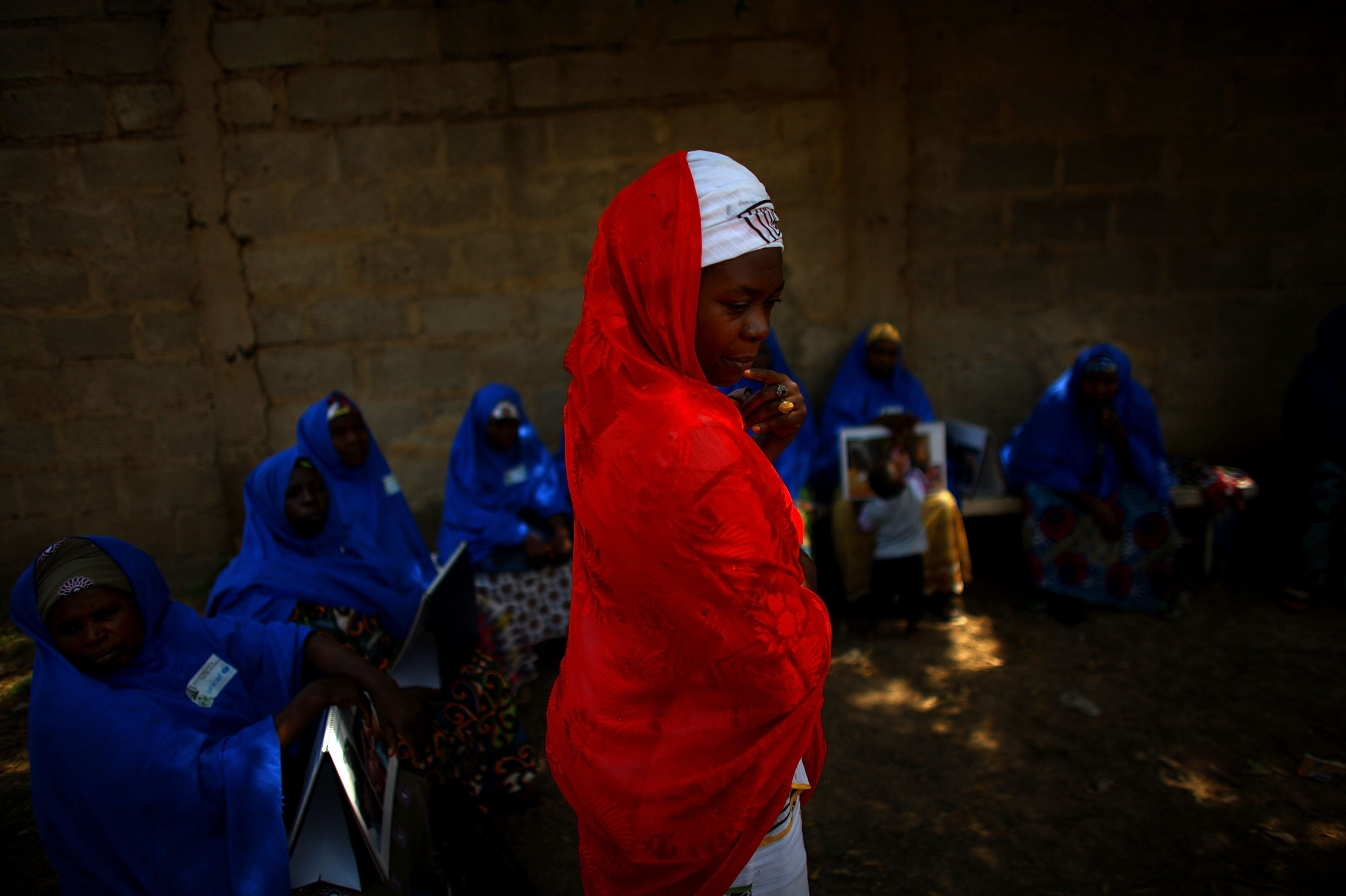 Hawa Bello, a social mobilization consultant with UNICEF in Kano, meets with community volunteers. The volunteers are given a small stipend to guide polio immunization teams through their individual neighborhoods. It's the volunteer's job to make sure every child under 5 in a given neighborhood gets vaccinated.