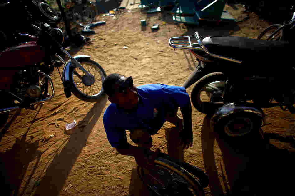 Sani Mohamed is a welder and mechanic at a shop run by polio victims in Kano.