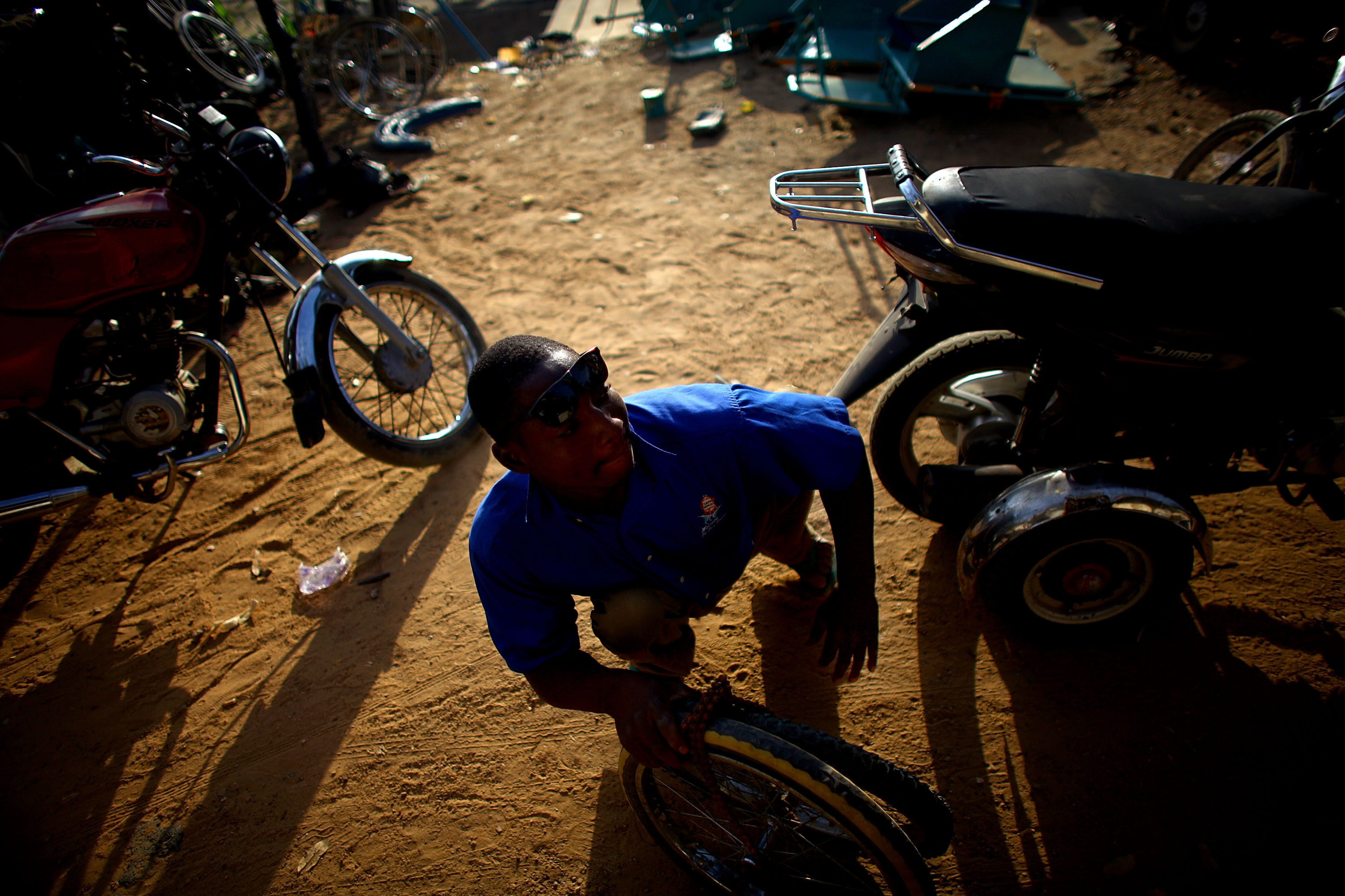 Sani Mohamed is a welder and mechanic at a shop run by polio victims in Kano.