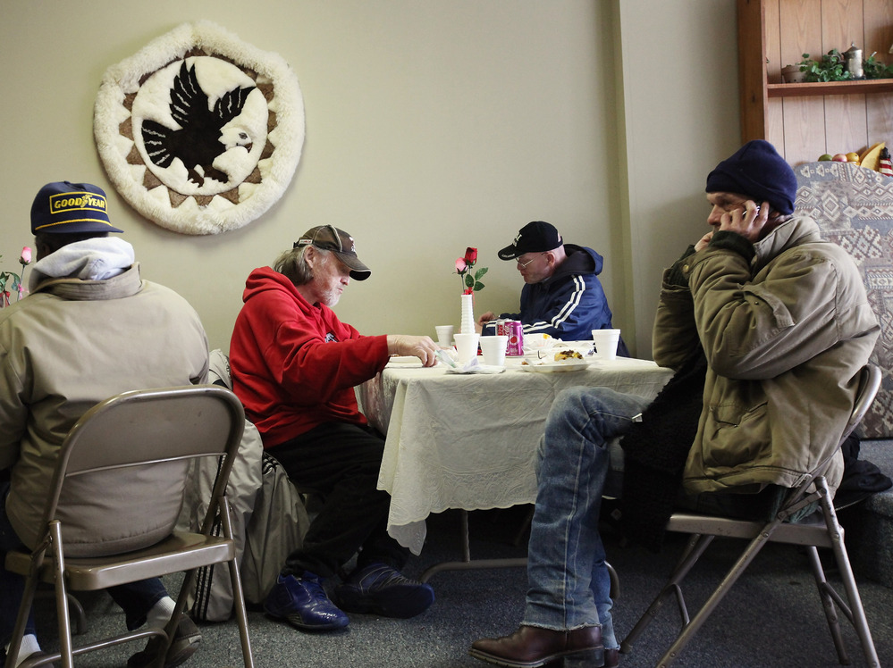 People eat a free community meal at The Center in Lima, Ohio, earlier this year. Although more than 46 million Americans are poor, the issue has gotten little attention in the presidential race.