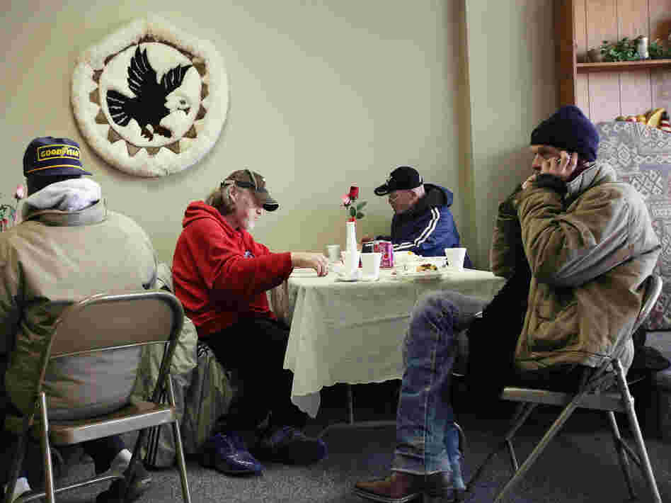 People eat a free community meal at The Center in Lima, Ohio, earlier this year. Although more than 46 million Americans are poor, the issue has gotten little attention in the presidential race.