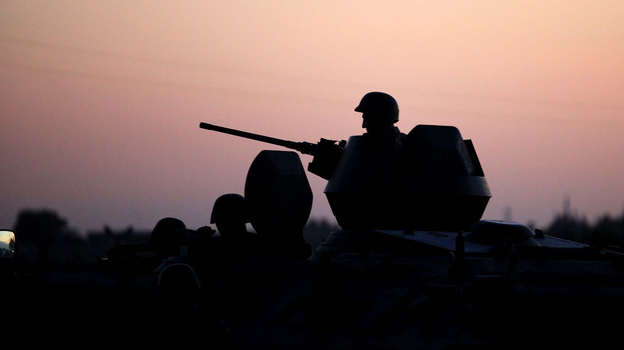 Turkish soldiers stand near the Turkey-Syria border in Akcakale, Turkey, early Friday. (AP)