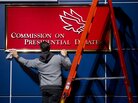 A worker cleans a sign before Tuesday's presidential debate at Hofstra University in Hempstead, N.Y. A worker cleans a sign before Tuesday's presidential debate at Hofstra University in Hempstead, N.Y.