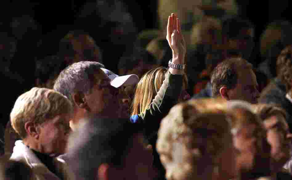 An audience member holds up his hand at a Mitt Romney town hall meeting in Dayton, Ohio, in March. Audience members will be allowed to ask questions at the second presidential debate, being held Tuesday night in Hempstead, N.Y.
