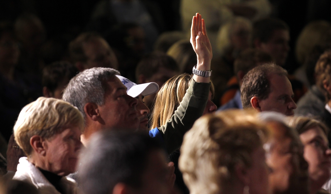 An audience member holds up his hand at a Mitt Romney town hall meeting in Dayton, Ohio, in March. Audience members will be allowed to ask questions at the second presidential debate, being held Tuesday night in Hempstead, N.Y.