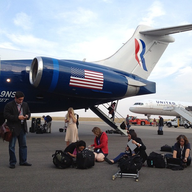Campaign reporters file their stories on the tarmac in Denver after Mitt Romney took questions in flight. <a href=
