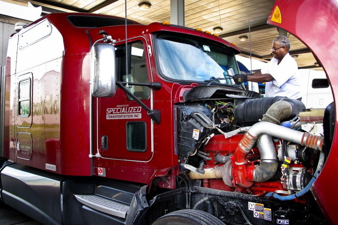 Errol Giwa, en route to Washington, D.C., fuels up and wipes down his windshield at the truck stop in Jessup, Md. He says in his 34 years as a truck driver, he has heard of many instances of human trafficking at truck stops but hasn't seen it with his own eyes. "If you are looking for that sort of thing, it's not hard to find on the road," Giwa says.