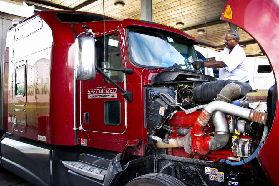 Errol Giwa, en route to Washington, D.C., fuels up and wipes down his windshield at the truck stop in Jessup, Md. He says in his 34 years as a truck driver, he has heard of many instances of human trafficking at truck stops but hasn't seen it with his own eyes. "If you are looking for that sort of thing, it's not hard to find on the road," Giwa says.