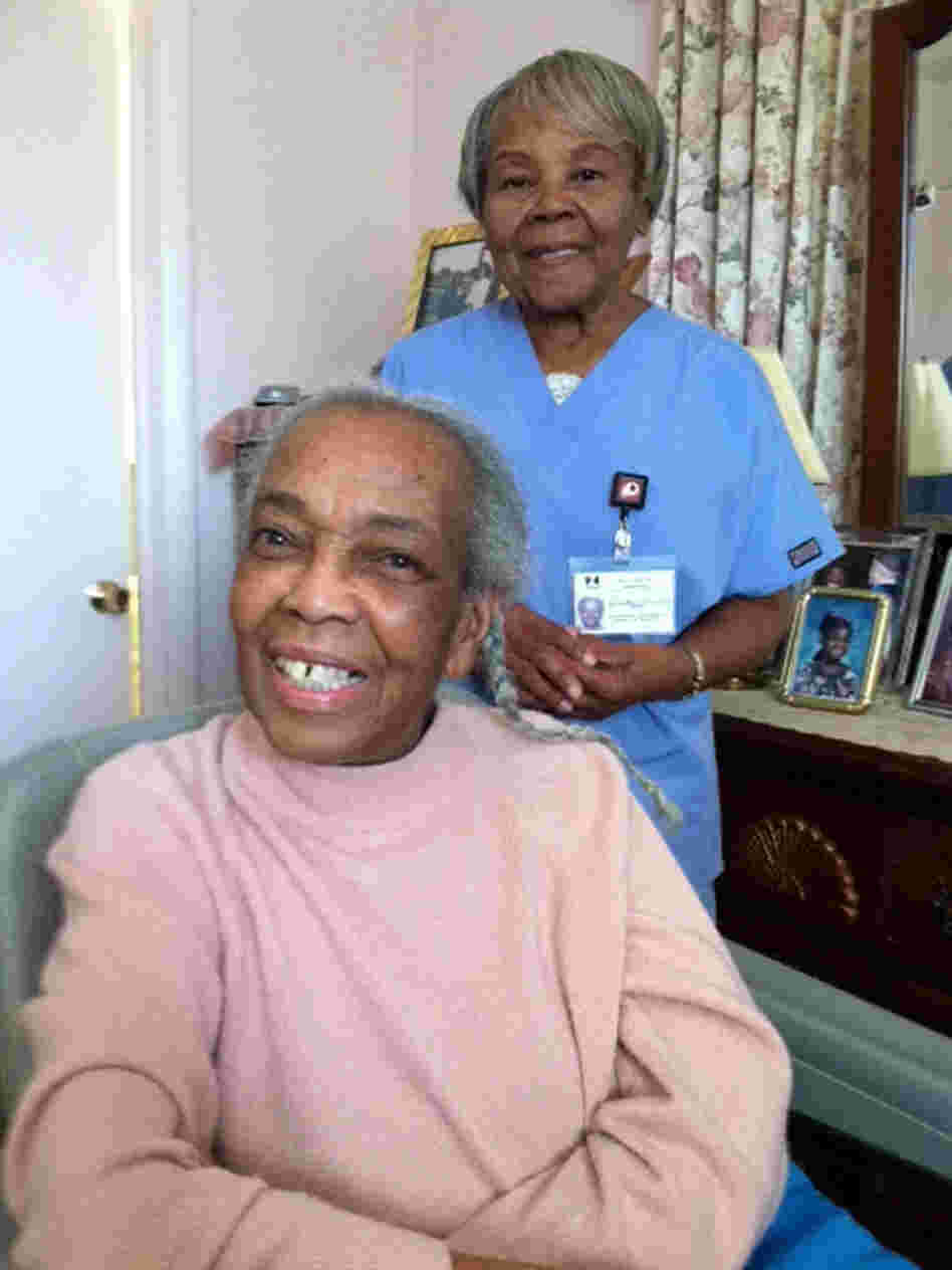 Onether Lowery, 80, (standing) is a home health aide for Rosalie Lewis, 86. As a whole, the aides are largely female and far older than women in the general workforce.