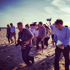 Reporter Ashley Parker transmitted these two different views of the campaign trail via Instagram. In the photo on the left, Mitt and Ann Romney stroll on the beach. On the right, the media pool chases after them.