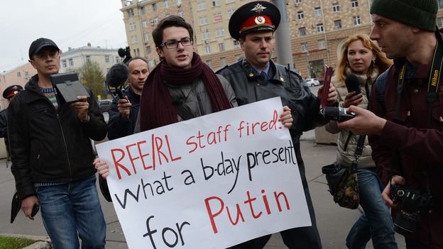 Police officers detain Kirill Filimonov, one of the supporters of Radio Liberty in Moscow during a recent protest. The service will stop AM radio broadcasts and will become an Internet operation. It can also be heard on short wave radio.