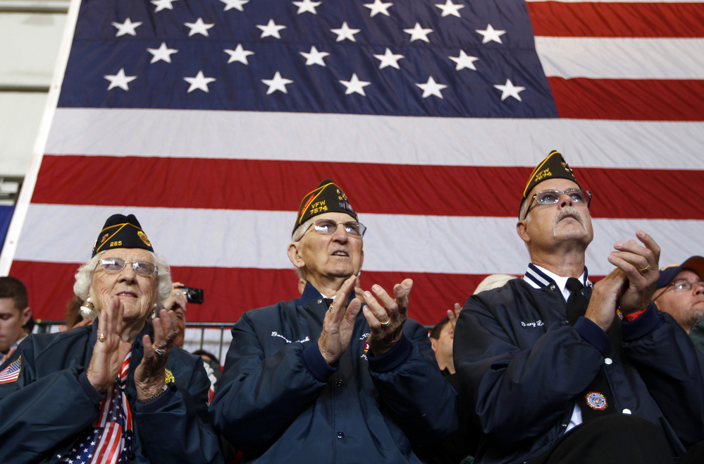 Veterans applaud at an Oct. 8 campaign event in Swanton, Ohio, for Republican vice presidential candidate Paul Ryan. Health care and unemployment are among veterans' chief concerns this election season, and both the Obama and the Romney campaigns have offered solutions.