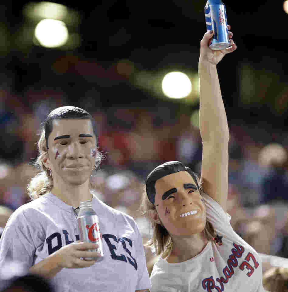 Fans wear President Obama and Mitt Romney masks at the Atlanta Braves-Miami Marlins game Sept. 25 in Atlanta. One of many quirky election year predictors is based on which candidate's likeness sells better as a Halloween mask.