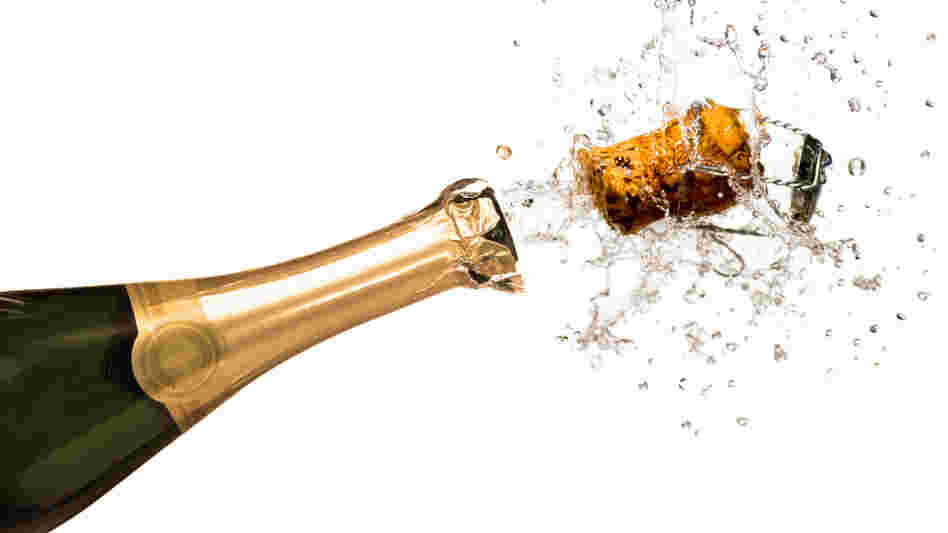 Close-up of explosion of champagne bottle cork